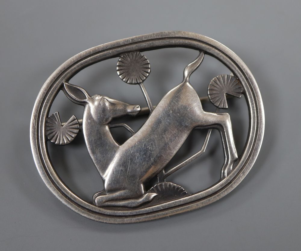 A 1933-1944 Georg Jensen sterling kneeling deer oval brooch, design no. 256, 43mm, gross 12 grams.